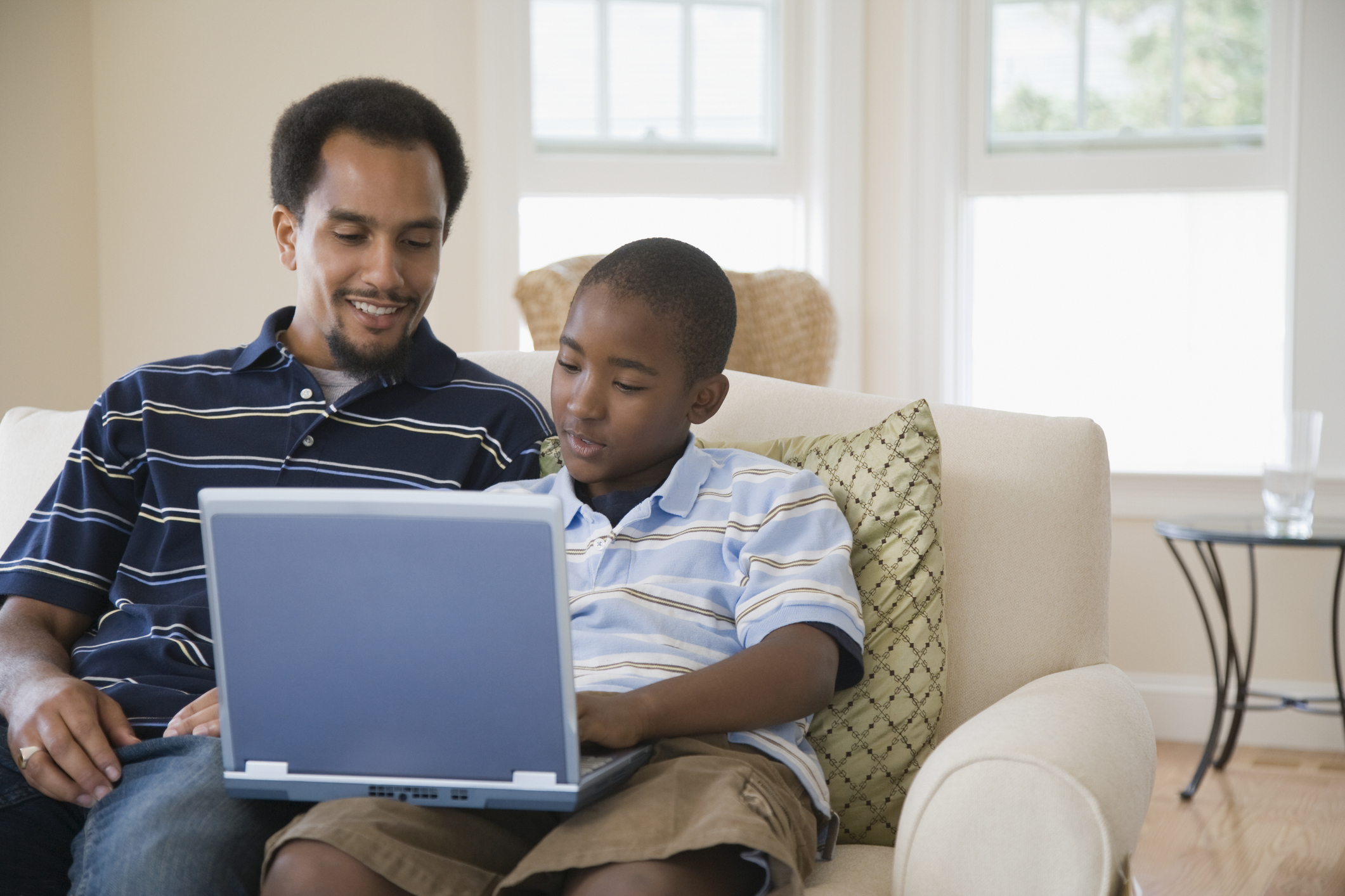Young man and his son using a laptop